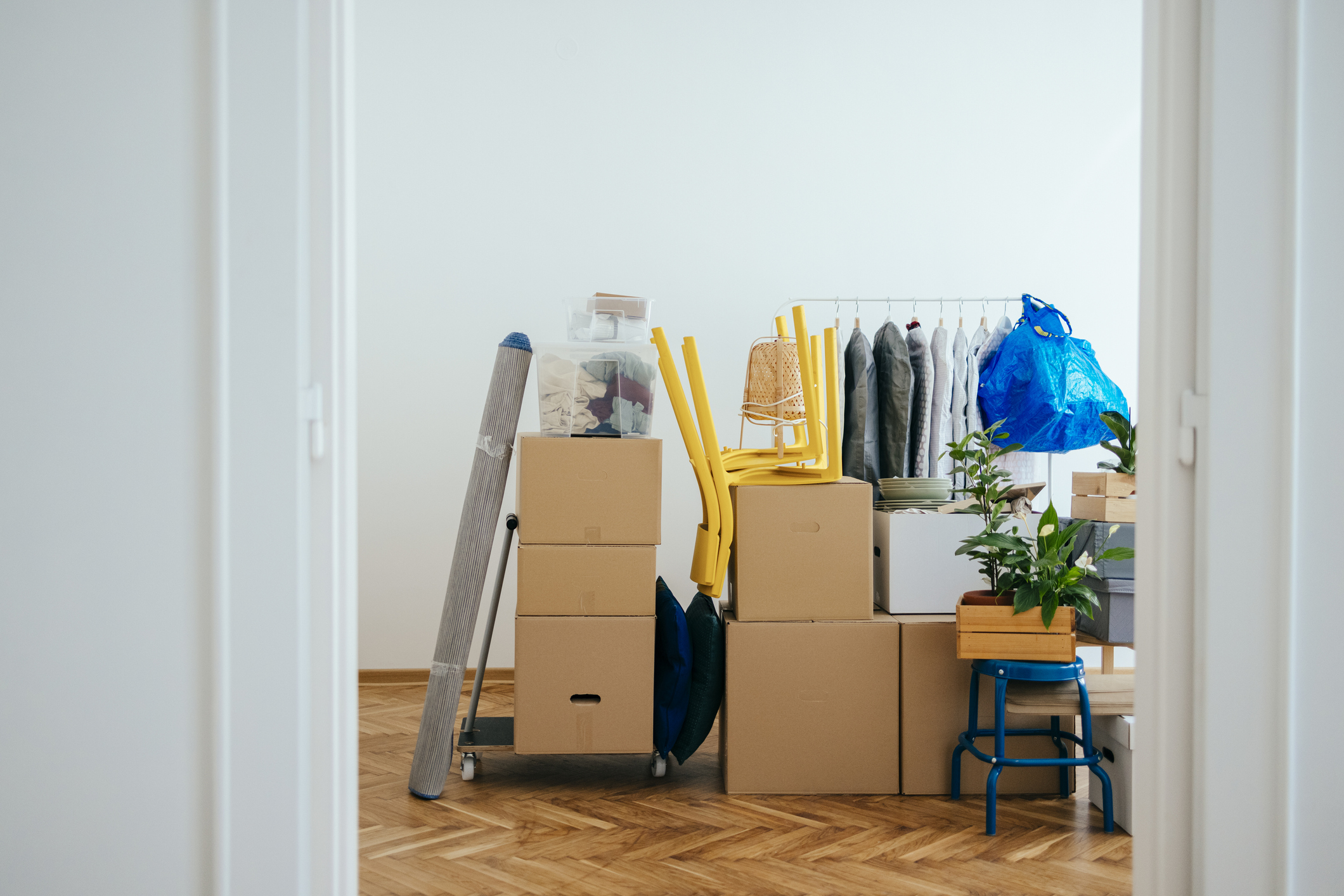 Moving boxes stacked in empty apartment awaiting movers.