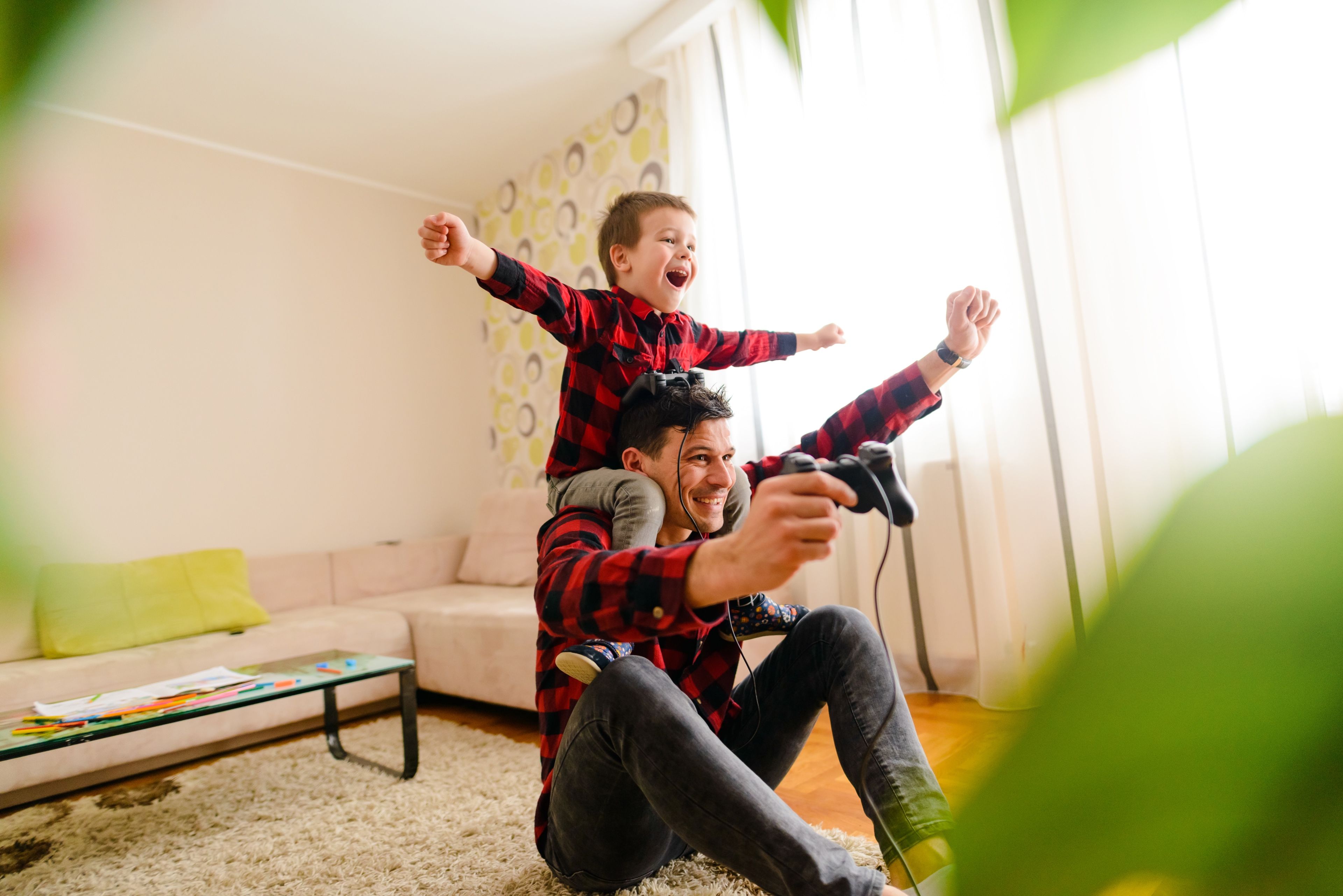 Dad playing games with son. How to Pick the Right Mortgage Lender for Your Refinance 5 Things Besides Interest Rate to Consider