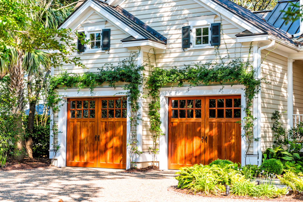 Charming garage with ivy and wood doors.