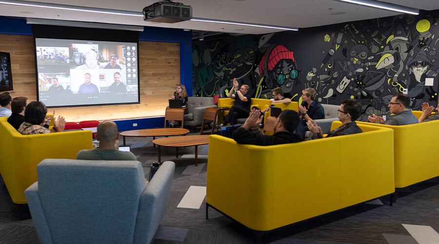 Lowe's Innovation Labs team member meeting in common area listening to presenter.