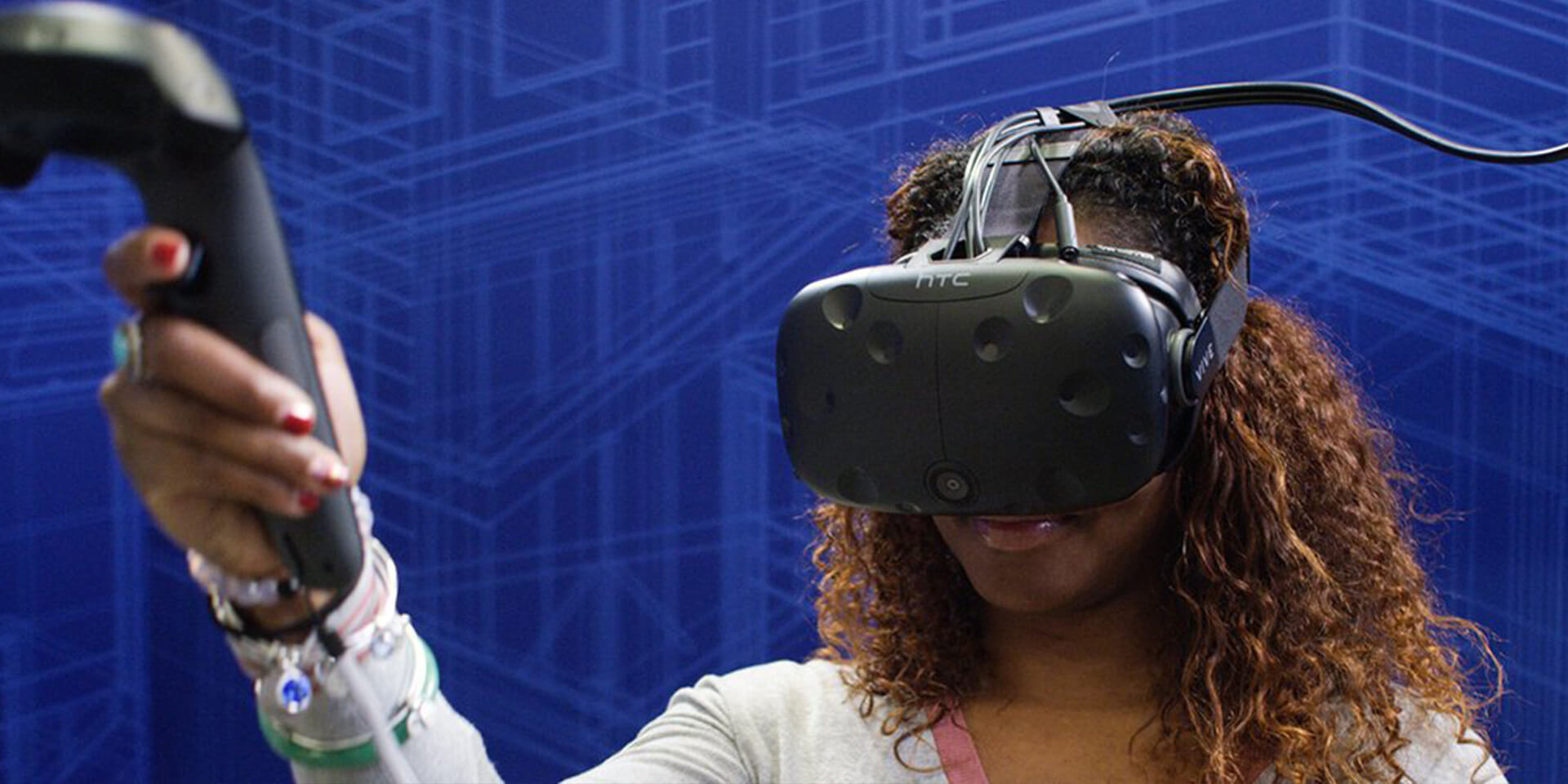 African-American female wearing VR headset learning DIY skills in a Lowes Home Improvement holoroom experience.